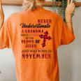 November Never Underestimate A Grandma Covered By The Blood Women's Oversized Comfort T-Shirt Back Print Yam