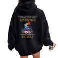 Never Underestimate Woman In Her Seventies Rides A Bicycle Women Oversized Hoodie Back Print Black