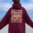 Never Underestimate A Woman With A Bionic Spine Surgery Women Oversized Hoodie Back Print Maroon