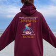 Never Underestimate Woman In Her Seventies Rides A Bicycle Women Oversized Hoodie Back Print Maroon
