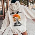Never Underestimate An Old Woman Who Loves Dogs February Women Oversized Hoodie Back Print Sand